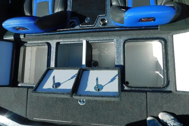 Slide: The Image of 2024 Ranger Z518 boat interior with storage compartments and blue seats. - 12