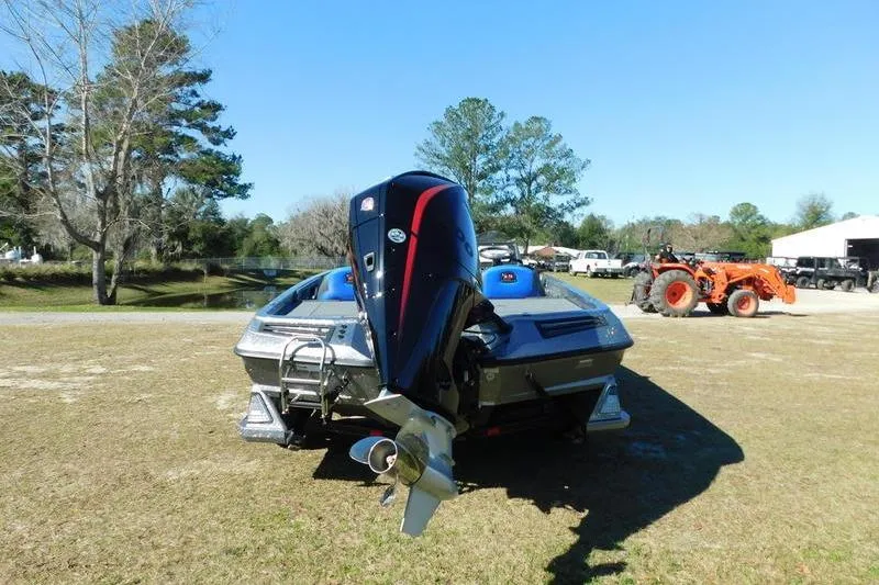 Slide: The Image of 2024 Ranger Z518 boat with outboard motor on grassy area, blue sky background. - 5