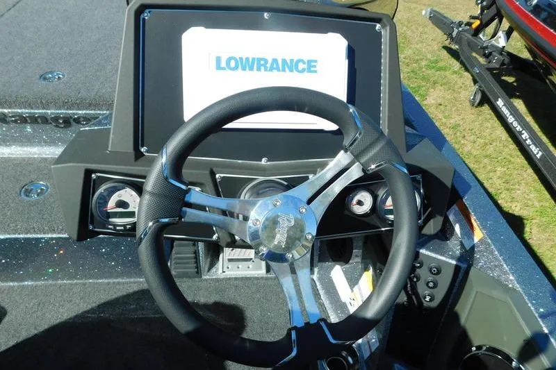 Slide: The Image of 2024 Ranger Z518 boat dashboard with Lowrance display and steering wheel. - 9