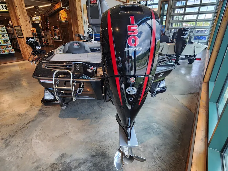 Slide: The Image of 2024 Ranger Z518 Ranger Cup Equipped boat with 150 HP motor displayed indoors. - 3