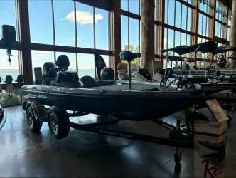 Slide: The Image of 2024 Ranger Z518 boat displayed indoors with large windows and scenic view. - 1
