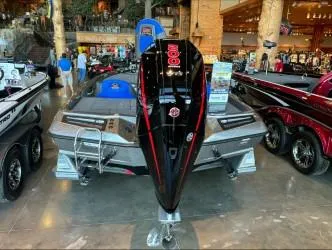 Slide: The Image of 2024 Ranger Z518 boat displayed indoors with powerful engine and sleek design. - 2