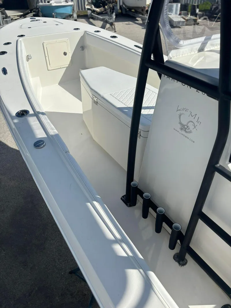 Slide: The Image of 2014 Andros Tarpon 26 boat interior with seating and rod holders. - 11