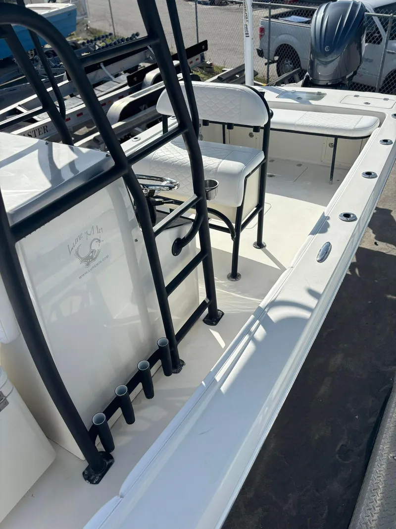 Slide: The Image of 2014 Andros Tarpon 26 boat interior with seating and rod holders. - 16