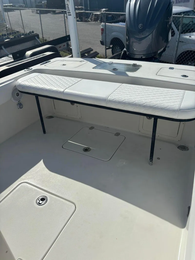 Slide: The Image of 2014 Andros Tarpon 26 boat interior with seating and storage compartments. - 18