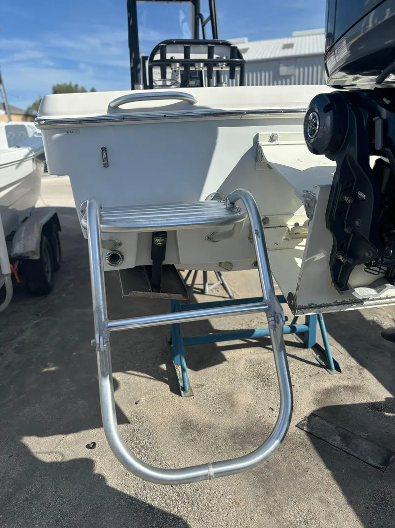 Slide: The Image of 2014 Andros Tarpon 26 boat with a metal swim ladder. - 19