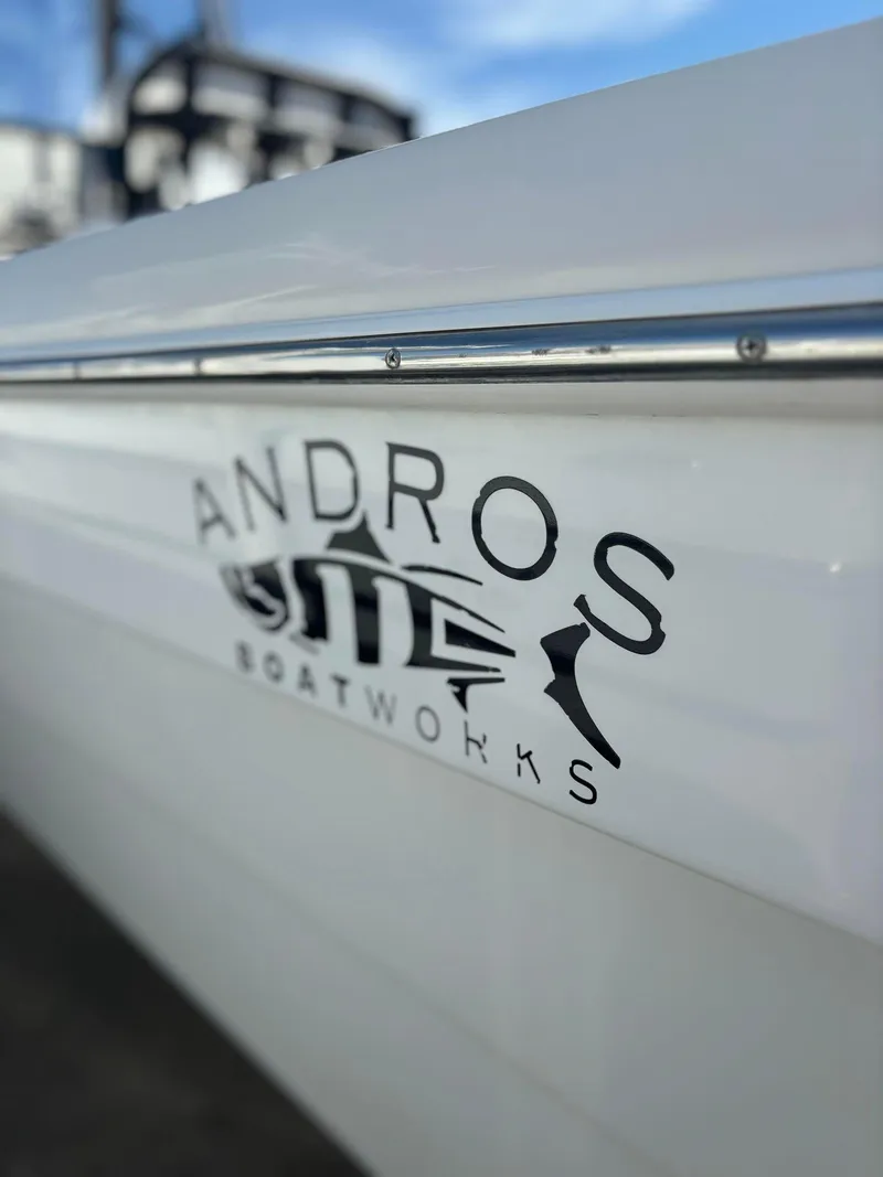 Slide: The Image of 2014 Andros Tarpon 26 boat side view with Andros Boatworks logo. - 5