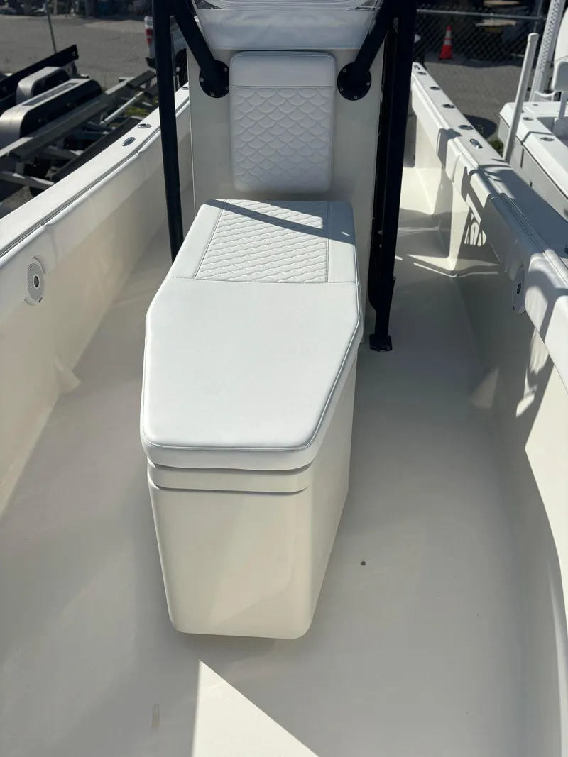 Slide: The Image of 2014 Andros Tarpon 26 boat interior with white cushioned seating. - 9
