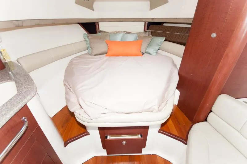 Slide: The Image of 2008 Boston Whaler 345 Conquest cabin interior with bed and pillows. - 16