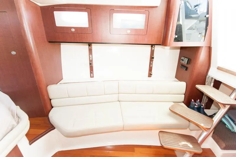 Slide: The Image of Interior of 2008 Boston Whaler 345 Conquest with white leather seating and wooden accents. - 18
