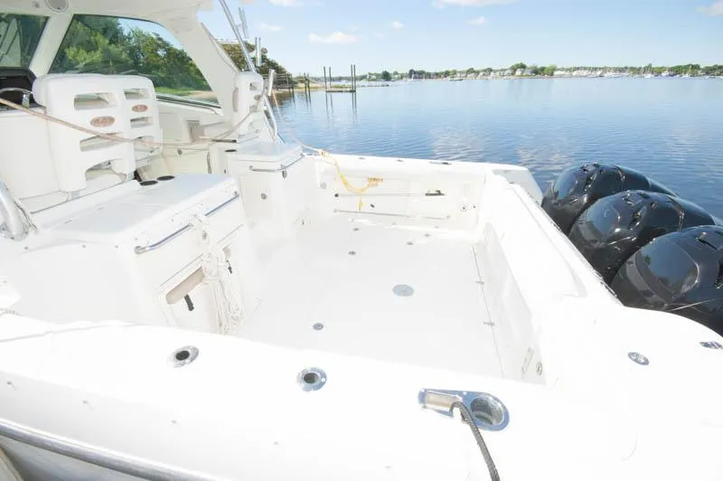 Slide: The Image of 2008 Boston Whaler 345 Conquest boat deck with triple outboard engines. - 2