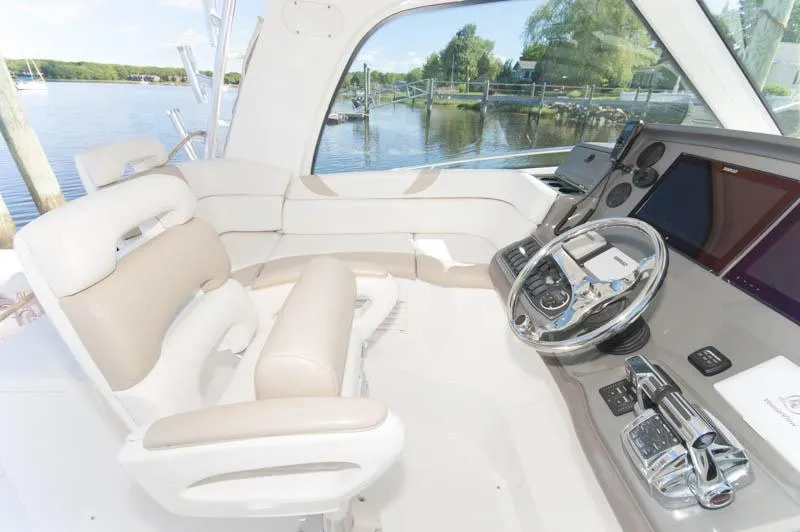 Slide: The Image of 2008 Boston Whaler 345 Conquest helm with luxurious seating and advanced navigation controls. - 4
