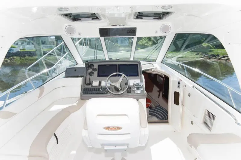 Slide: The Image of 2008 Boston Whaler 345 Conquest boat cockpit with modern navigation equipment. - 5