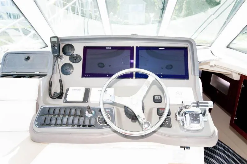 Slide: The Image of 2008 Boston Whaler 345 Conquest helm with dual navigation screens and control panel. - 6