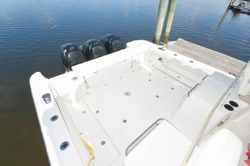 Slide: The Image of 2008 Boston Whaler 345 Conquest boat with triple outboard engines at dock. - 7