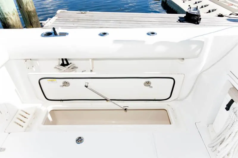Slide: The Image of 2008 Boston Whaler 345 Conquest boat storage compartment by the dock. - 8