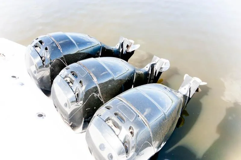 Slide: The Image of Triple outboard engines on a 2008 Boston Whaler 345 Conquest boat. - 9