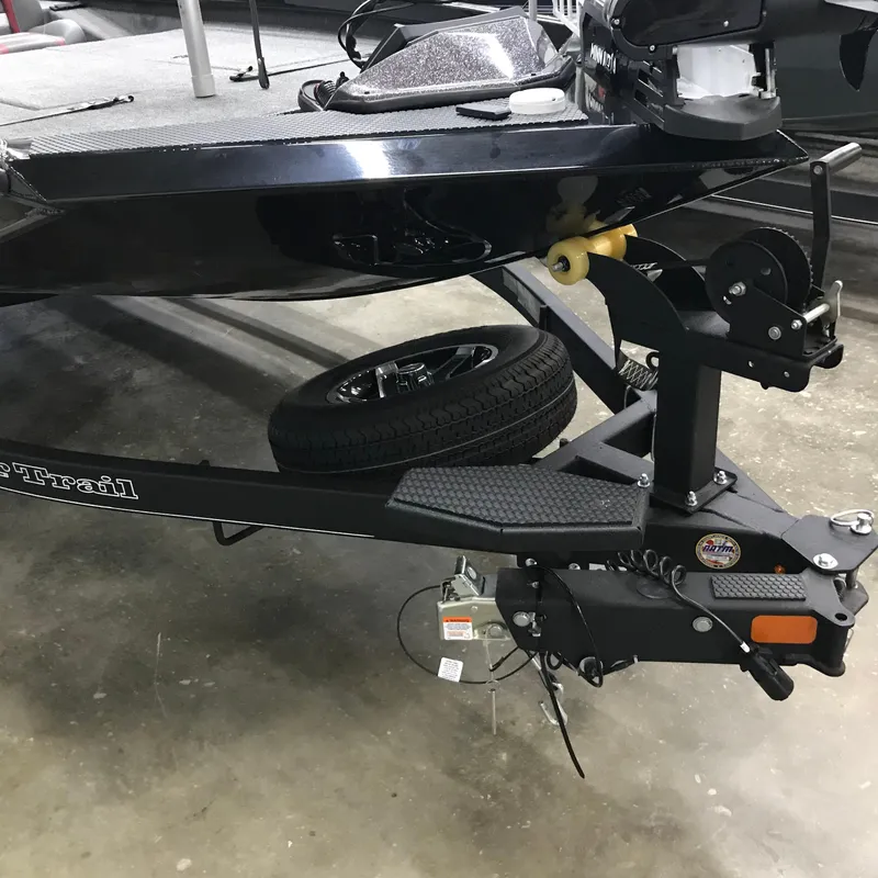 Slide: The Image of 2024 Ranger RT198P boat trailer with spare tire in a garage setting. - 11