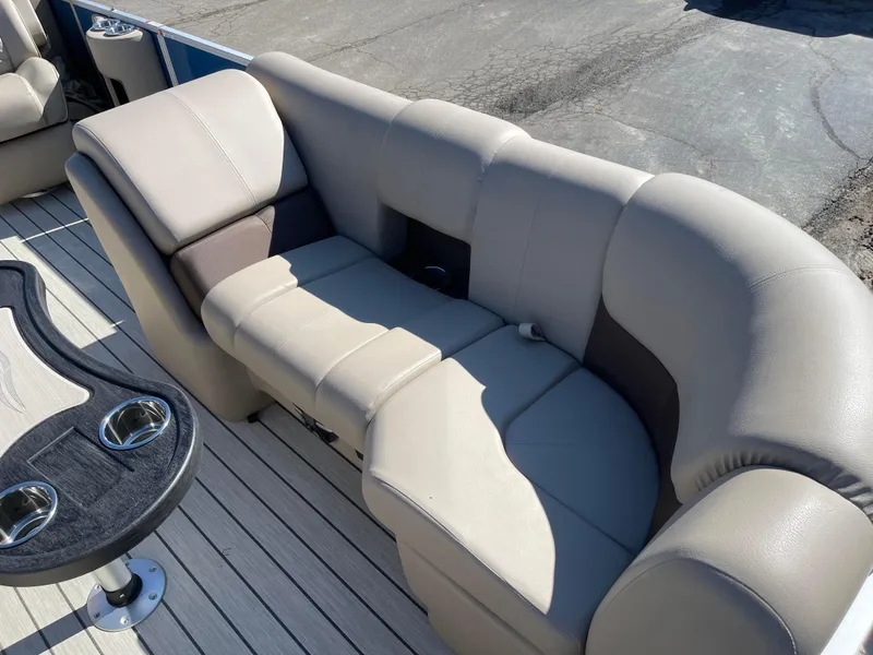 Slide: The Image of 2024 SunCatcher 322rc boat interior with plush seating and cup holders. - 12