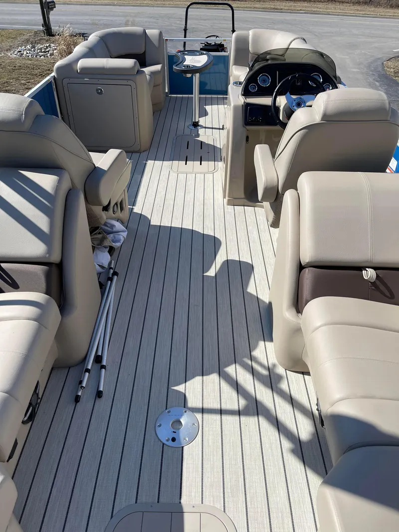 Slide: The Image of 2024 SunCatcher 322rc pontoon boat interior with beige seating and steering console. - 13