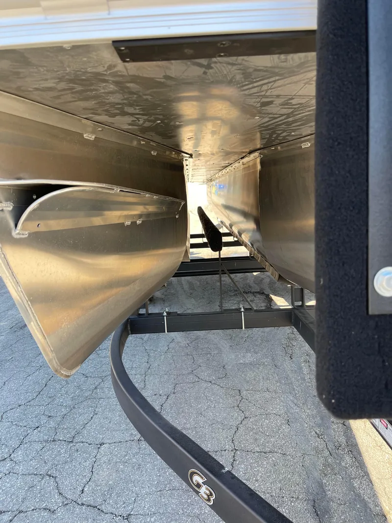 Slide: The Image of 2024 SunCatcher 322rc pontoon boat underside view on trailer. - 15