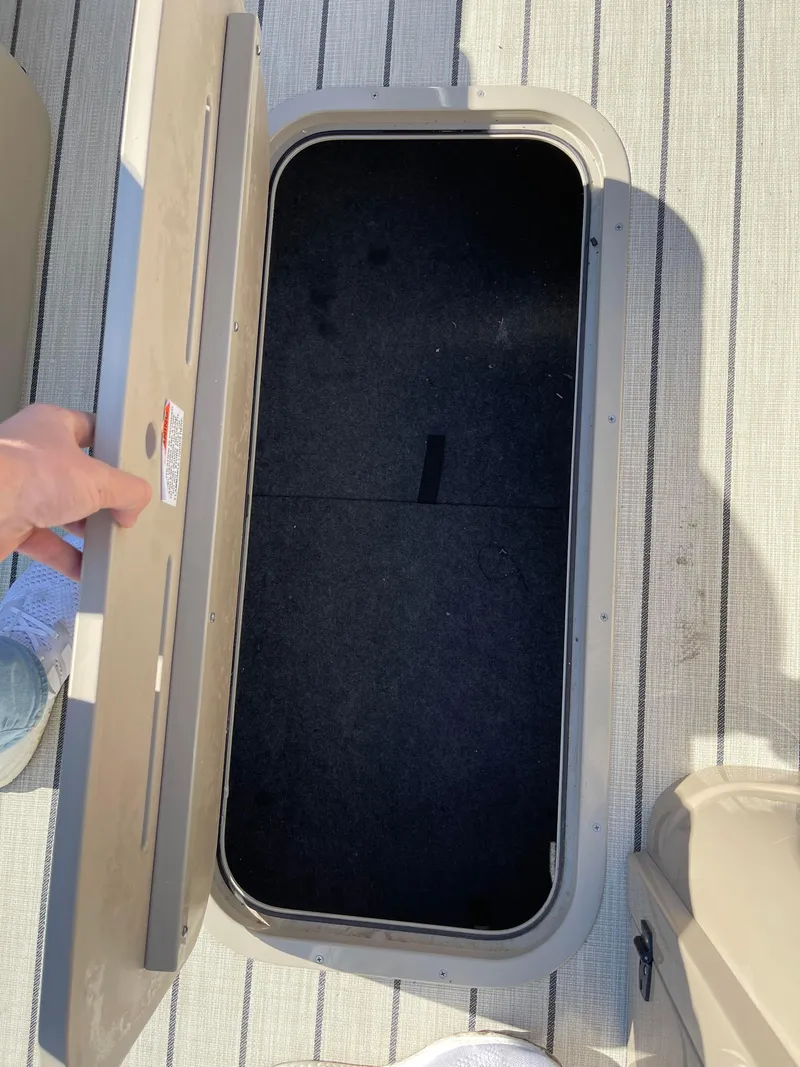 Slide: The Image of Open storage compartment on 2024 SunCatcher 322rc boat. - 16