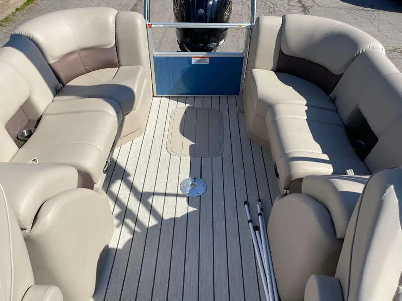 Slide: The Image of 2024 SunCatcher 322rc pontoon boat interior with beige seating and spacious deck. - 19