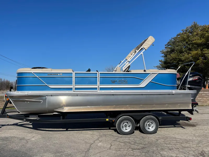 Slide: The Image of 2024 SunCatcher 322rc pontoon boat on a trailer under a clear blue sky. - 2