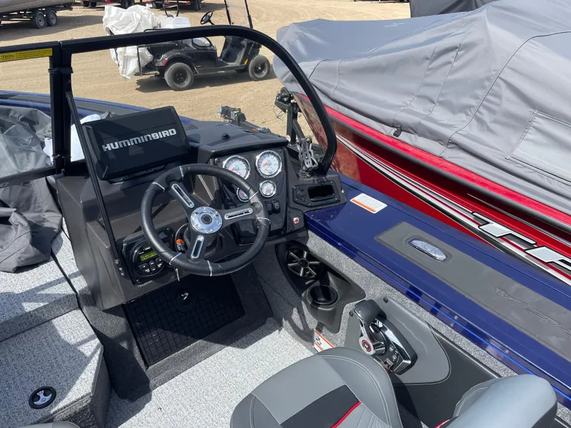 Slide: The Image of 2024 Tracker Targa V-19 Combo boat interior with steering wheel and control panel. - 10