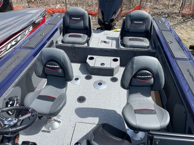 Slide: The Image of 2024 Tracker Targa V-19 Combo boat interior with four seats and steering wheel. - 14