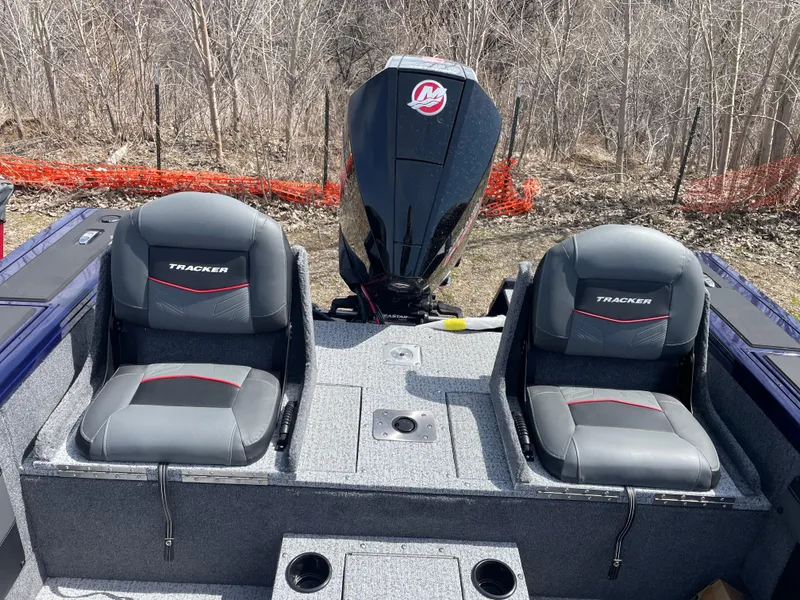 Slide: The Image of 2024 Tracker Targa V-19 Combo boat interior with two seats and an outboard motor. - 7