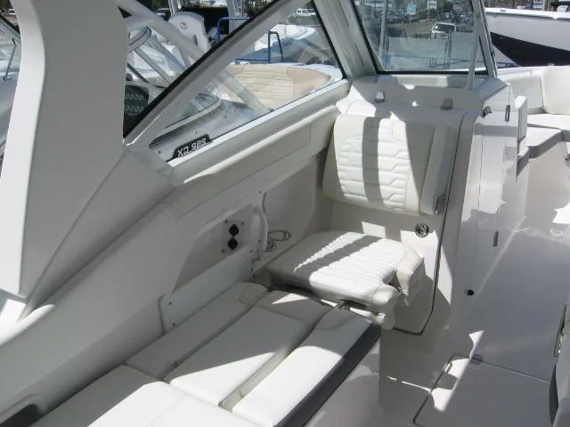 Slide: The Image of Interior of 2024 Edgewater 262 CX boat with white seating and modern design. - 10