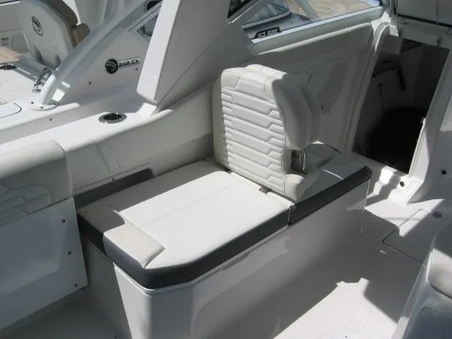 Slide: The Image of 2024 Edgewater 262 CX boat interior seating area with white upholstery. - 3