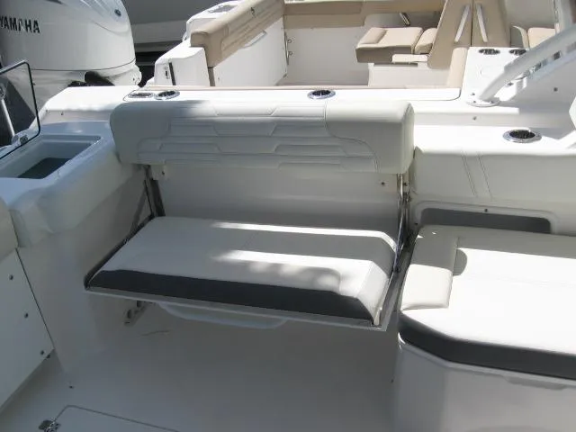 Slide: The Image of 2024 Edgewater 262 CX boat interior with foldable seating and white upholstery. - 4