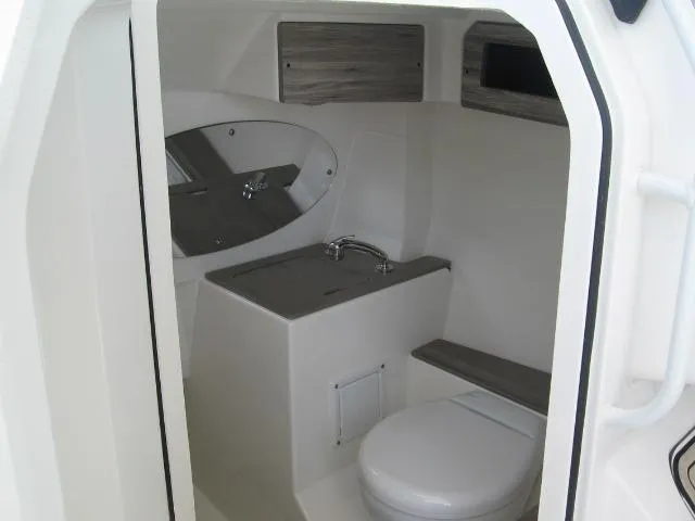 Slide: The Image of 2024 Edgewater 262 CX boat interior bathroom with sink and toilet. - 8