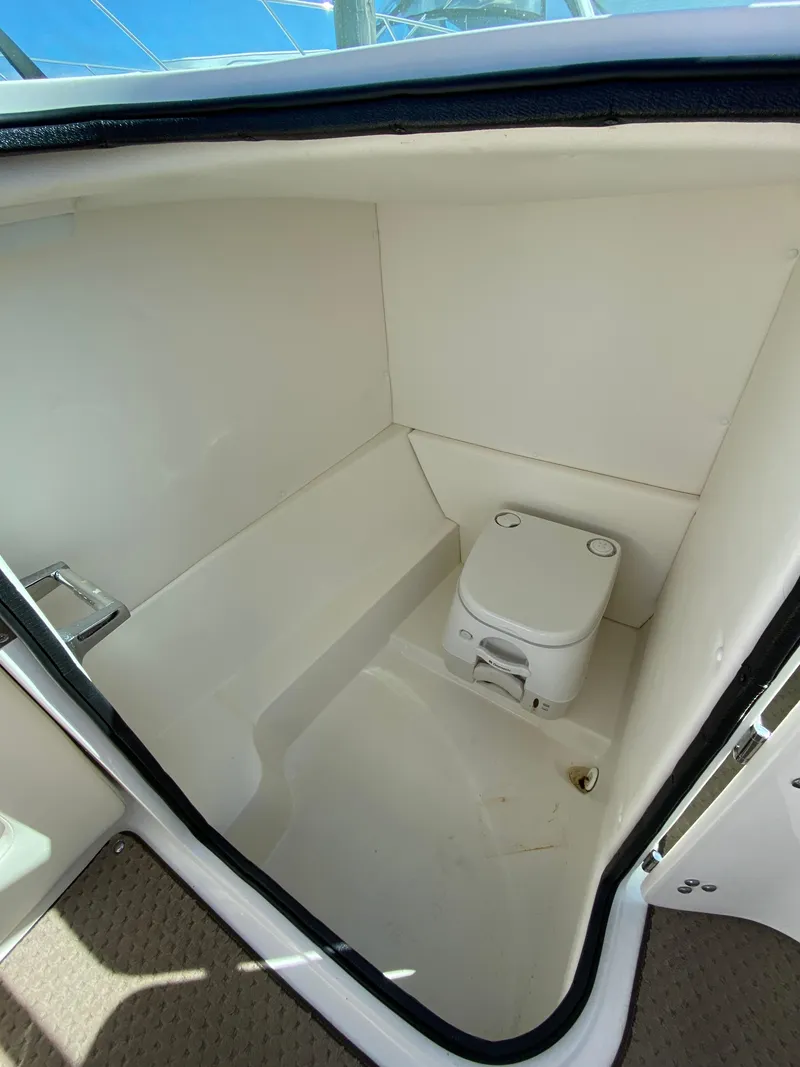 Slide: The Image of 2011 Sea Ray 240 Sundeck boat interior with portable toilet. - 17