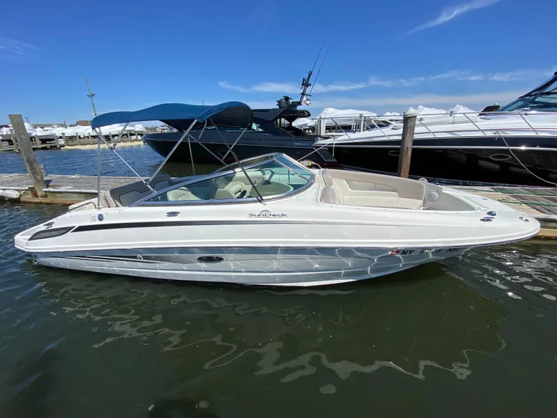 Slide: The Image of 2011 Sea Ray 240 Sundeck boat docked in marina. - 21