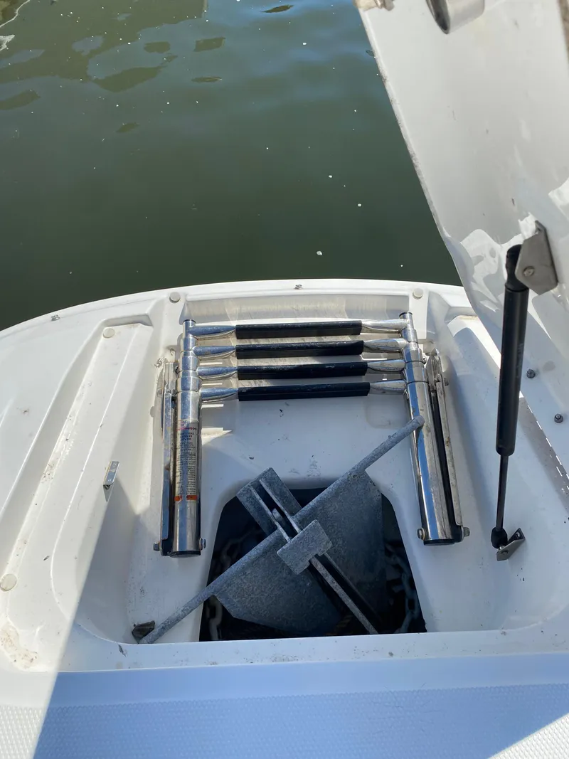 Slide: The Image of 2011 Sea Ray 240 Sundeck anchor and ladder compartment. - 22
