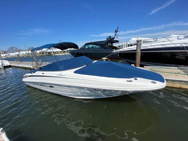 Slide: The Image of 2011 Sea Ray 240 Sundeck boat docked in a marina. - 26