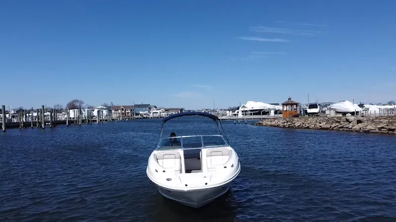 Slide: The Image of Sea Ray 240 Sundeck 2011 boat cruising in a marina on a sunny day. - 4