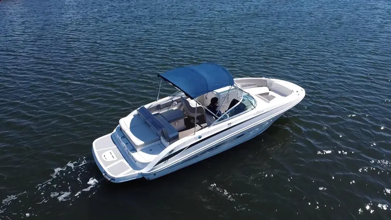 Slide: The Image of 2011 Sea Ray 240 Sundeck boat cruising on open water. - 5