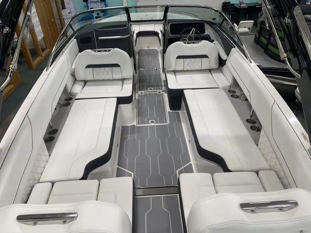 Slide: The Image of 2024 Regal LS6 boat with dual rear seats and modern deck design in showroom. - 12