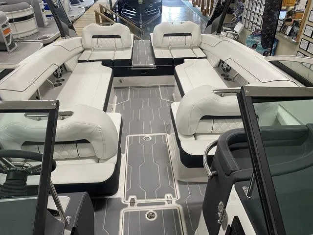 Slide: The Image of 2024 Regal LS6 boat with white cushioned seating and modern design. - 13