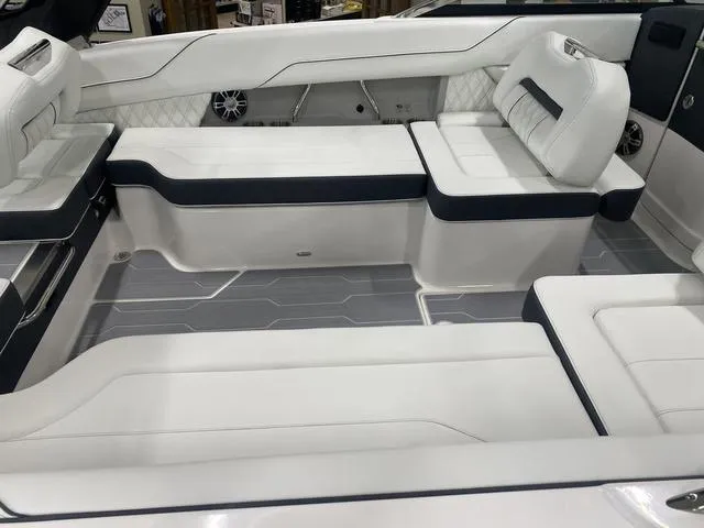 Slide: The Image of 2024 Regal LS6 luxury boat interior at showroom, featuring spacious seating and modern design. - 14