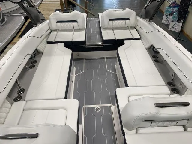 Slide: The Image of 2024 Regal LS6 boat interior with white seating and gray flooring. - 15