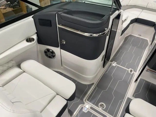 Slide: The Image of 2024 Regal LS6 boat interior with white leather seating and gray flooring. - 17