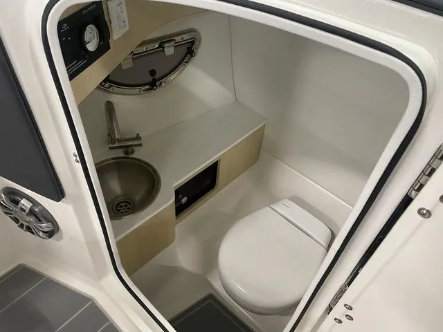 Slide: The Image of 2024 Regal LS6 boat interior with white seating and modern design. - 18