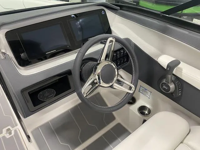 Slide: The Image of 2024 Regal LS6 boat dashboard with steering wheel, dual screens, and control panel. - 20
