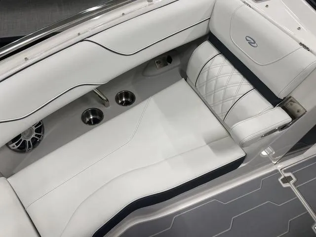 Slide: The Image of 2024 Regal LS6 boat interior with white seating and gray flooring. - 24