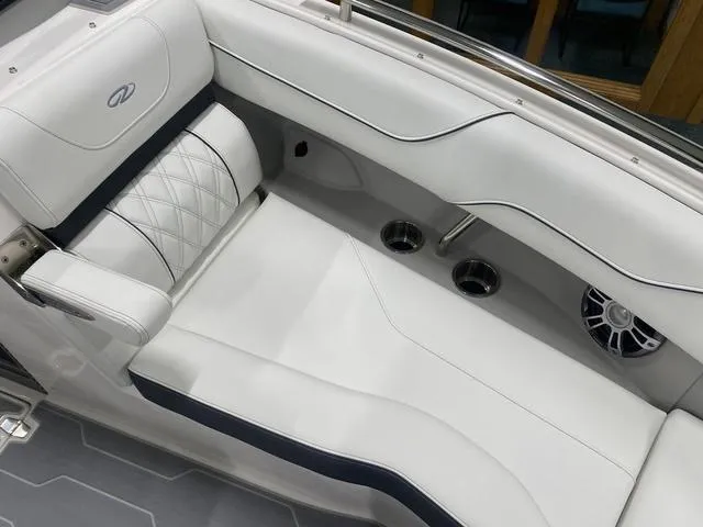 Slide: The Image of 2024 Regal LS6 boat interior with white and gray seating, modern design. - 25